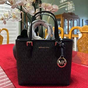 NWT Michael Kors Black Jet Set Travel top zip satchel with crossbody strap.